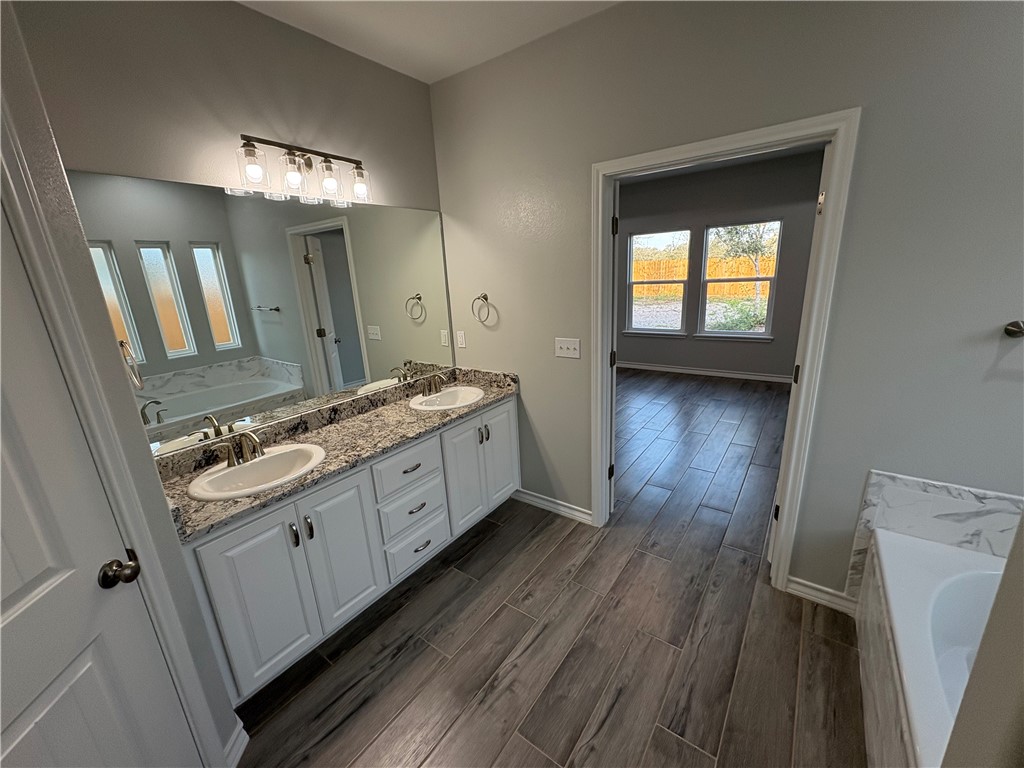 2533 Hewlett Ingleside, TX 78362 - Photo 16 of 23 a bathroom with a double vanity sink and a mirror