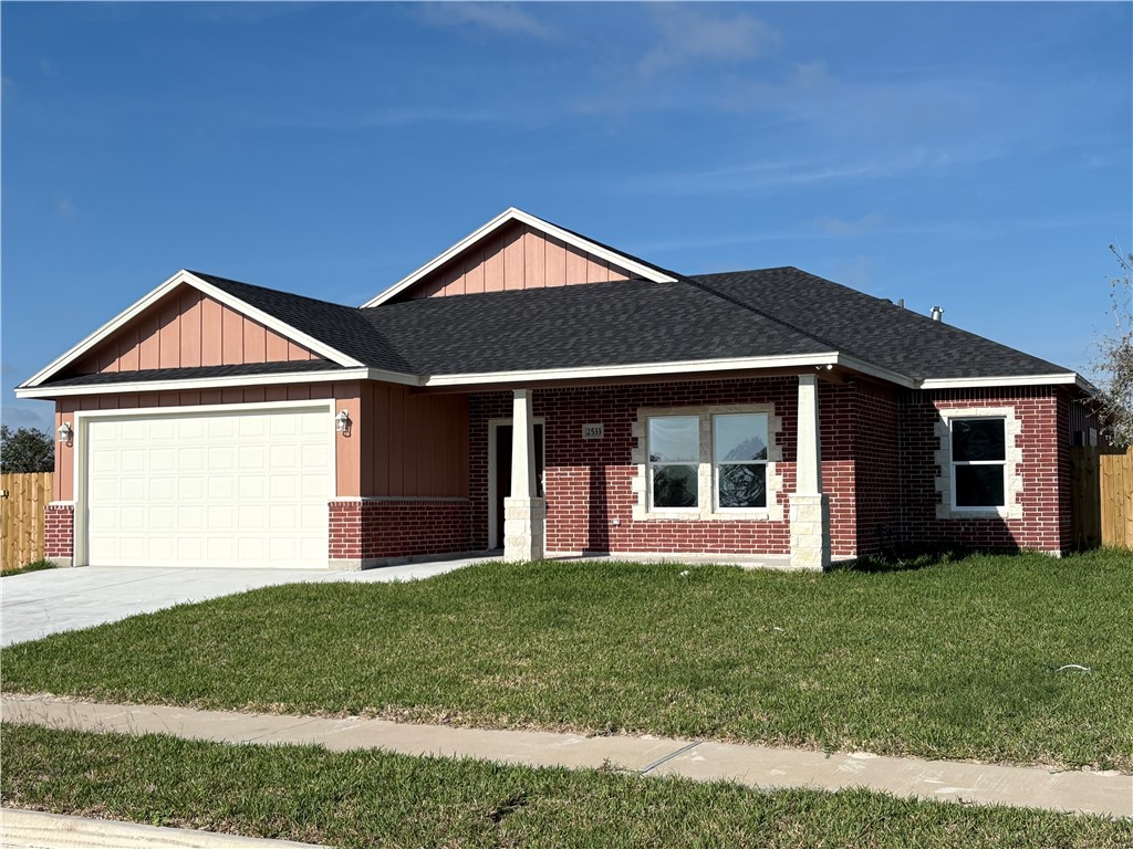 2533 Hewlett Ingleside, TX 78362 - Photo 2 of 23 a front view of a house with a yard and garage