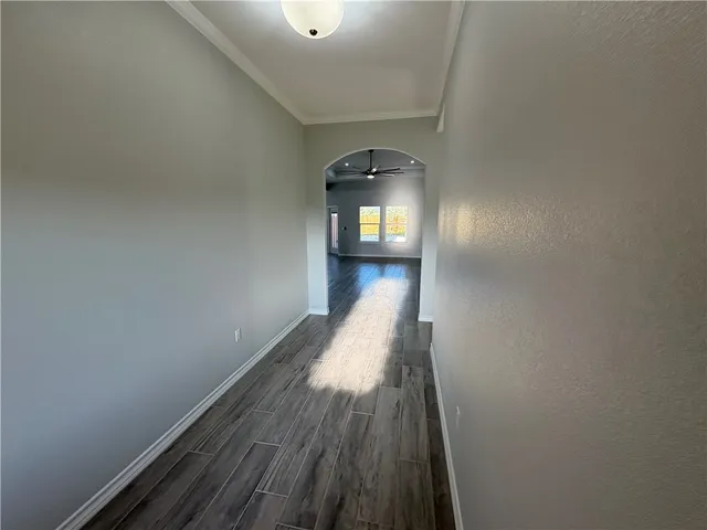 a view of a hallway with wooden floor