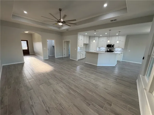 a view of a living room a kitchen and a chandelier
