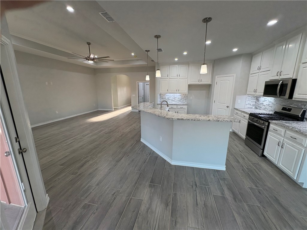 2533 Hewlett Ingleside, TX 78362 - Photo 6 of 23 a large kitchen with stainless steel appliances granite countertop a lot of counter space and wooden floor
