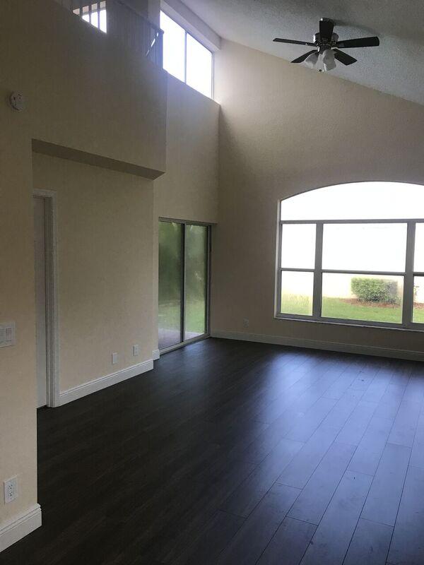 5212 Edenwood Road Riviera Beach, FL 33418 - Photo 4 of 7 an empty room with wooden floor and windows