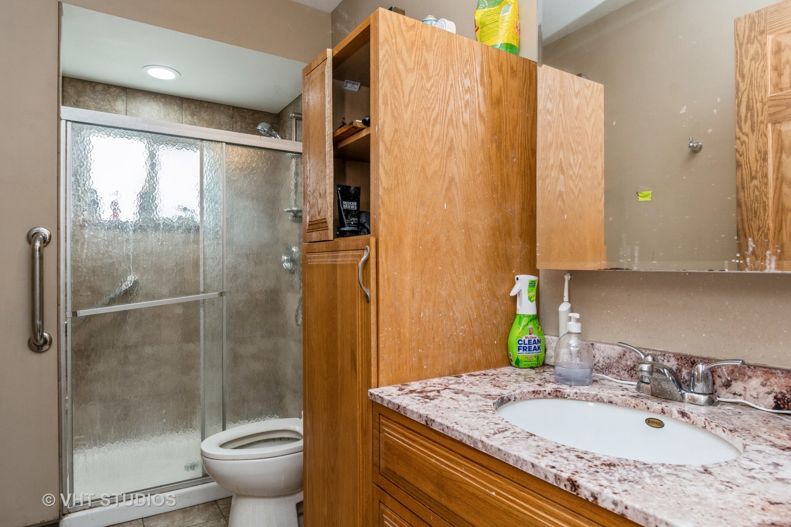1004 Riedy Road Lisle, IL 60532 - Photo 10 of 14 a bathroom with a granite countertop sink a toilet and shower