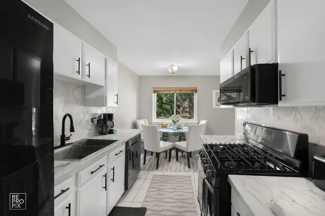 a kitchen with stainless steel appliances a stove sink microwave and cabinets