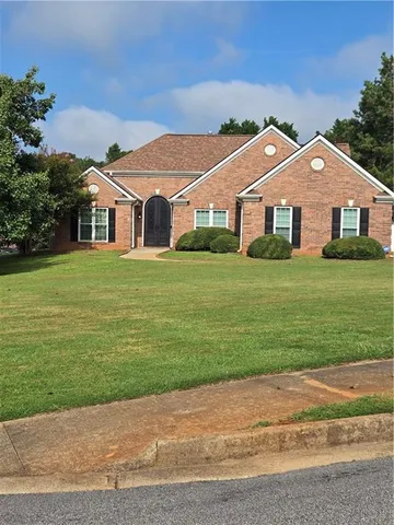 a front view of house with yard and green space