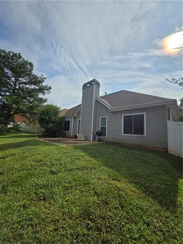 a view of a house with a back yard