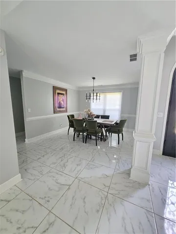 a view dining room with furniture and chandelier