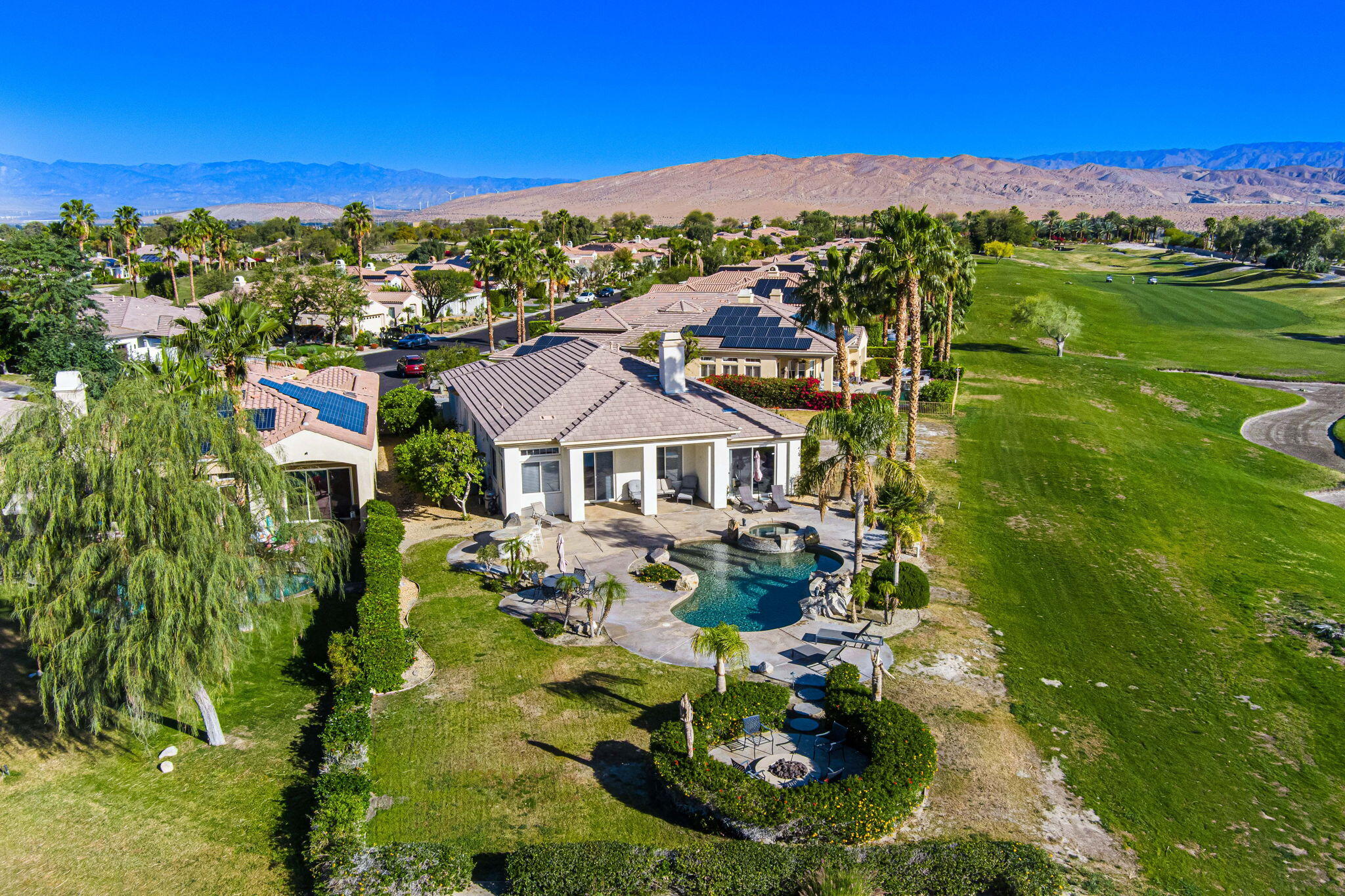 an aerial view of residential houses with outdoor space and trees all around