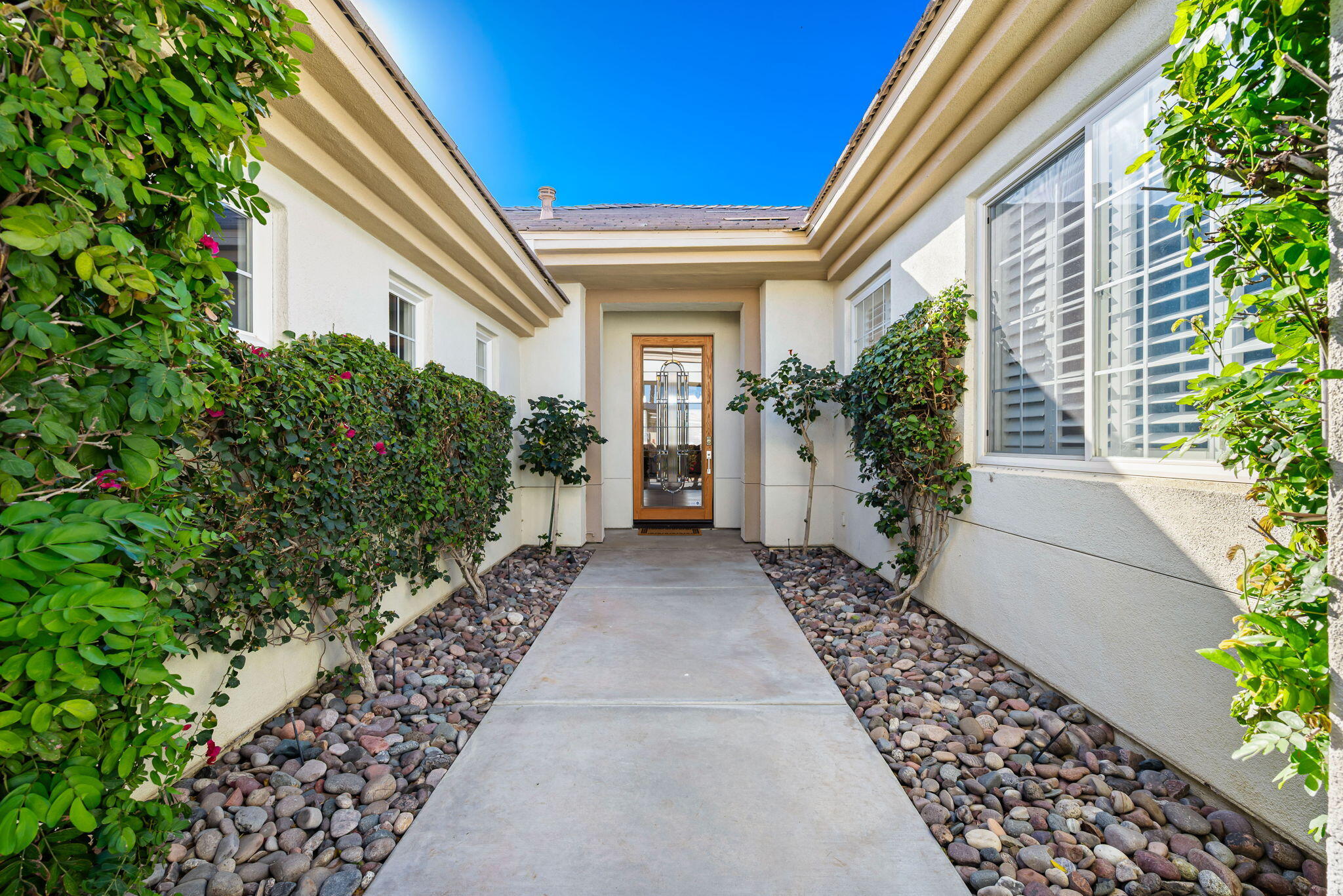 46 Vía Bella Rancho Mirage, CA 92270 - Photo 3 of 28 a view of a house with potted plants