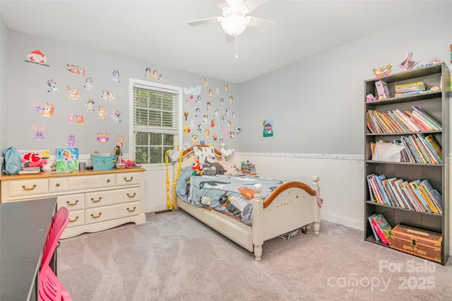 a bed room with a bed and a baby bed