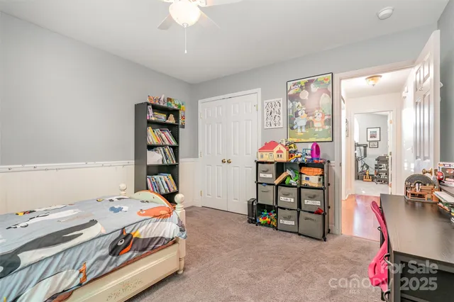 a bedroom that has a bed and a bookshelf in it
