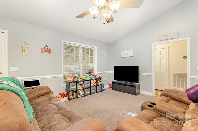 a bedroom with furniture and a flat screen tv