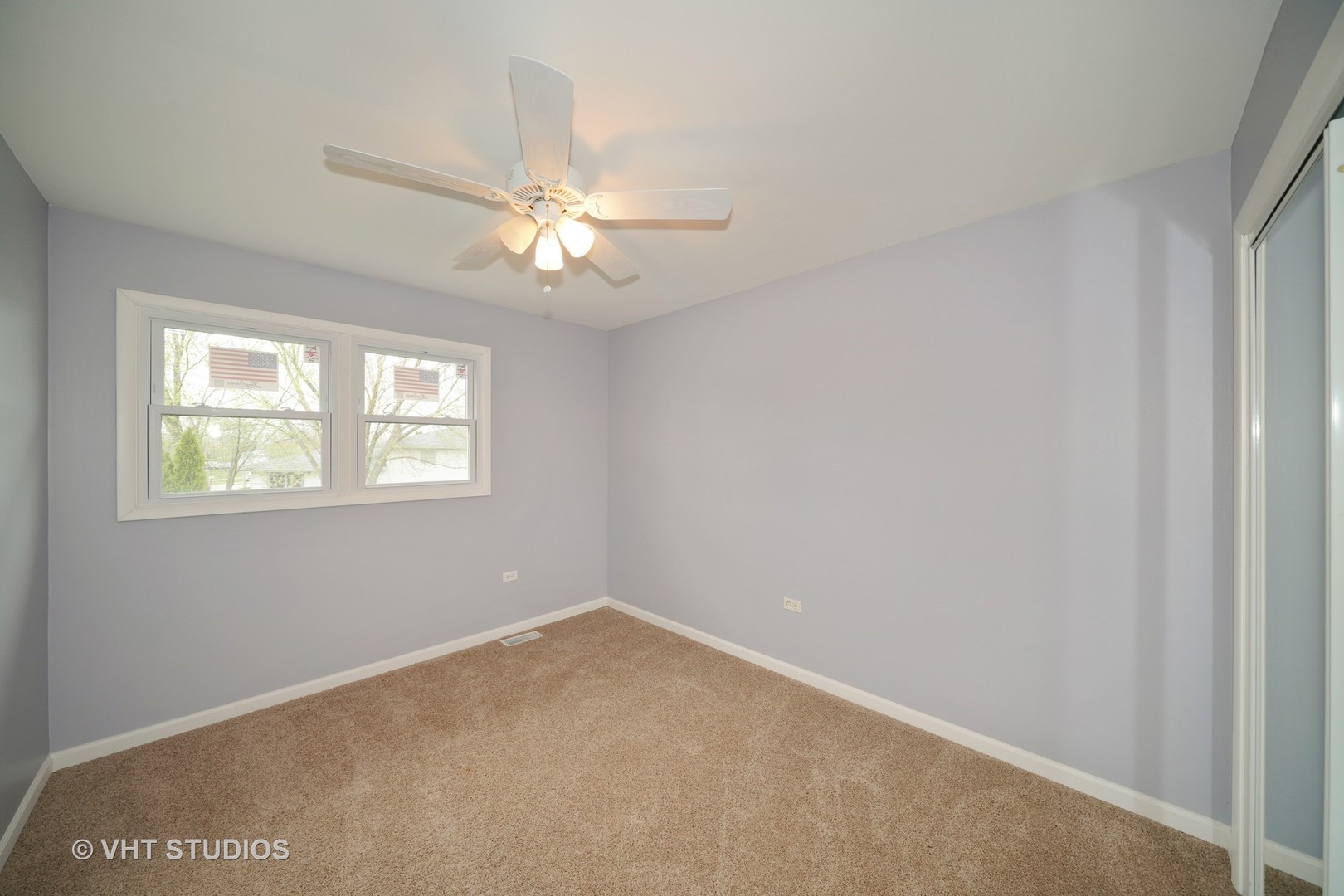 904 Knollside Road New Lenox, IL 60451 - Photo 5 of 16 an empty room with a window and a fan