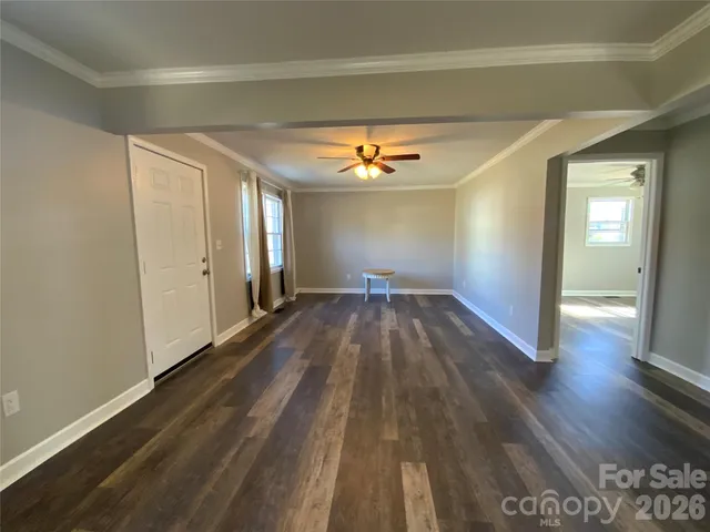 a view of a room with wooden floor