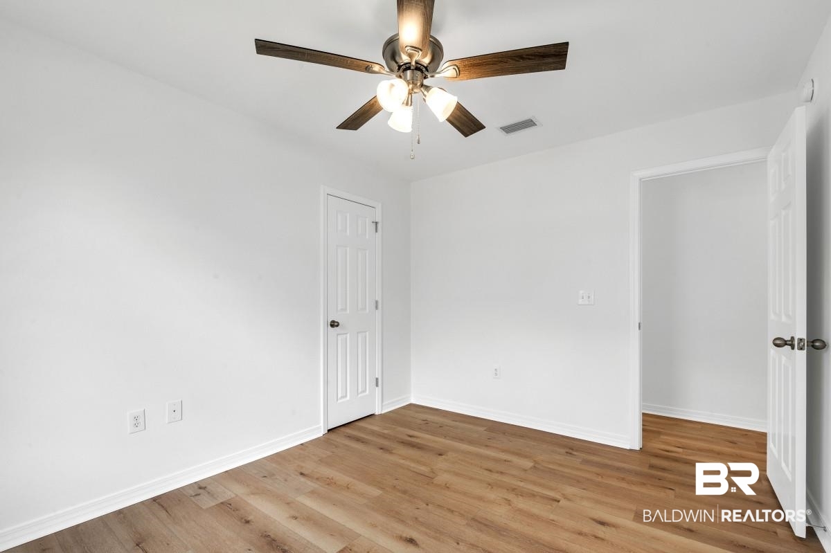 16927 Sugar Loop Foley, AL 36535 - Photo 37 of 50 Empty room with ceiling fan and light wood-style flooring