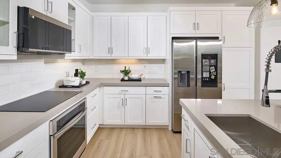 324 Beaker Road San Marcos, CA 92078 - Photo 3 of 19 a kitchen with stainless steel appliances granite countertop a sink stove and refrigerator