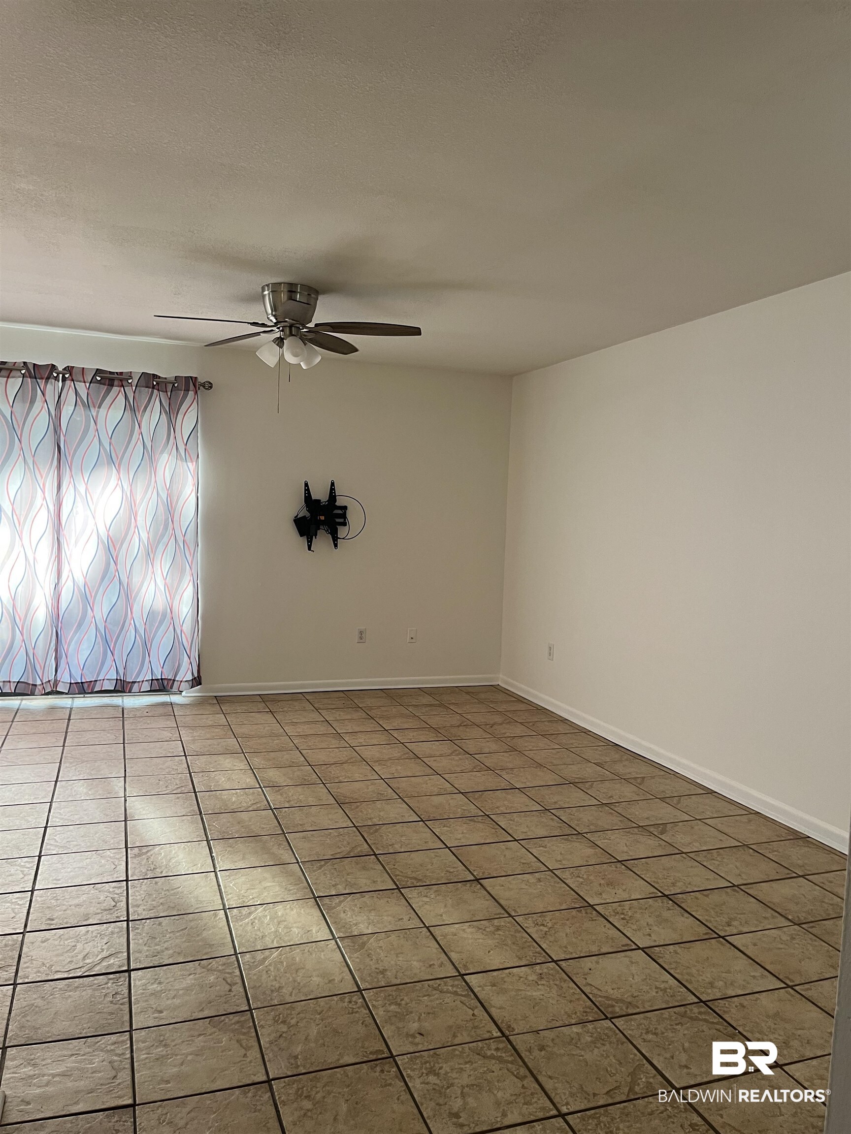 1146 North Alston Street Foley, AL 36535 - Photo 7 of 20 Tiled spare room with ceiling fan and a textured ceiling