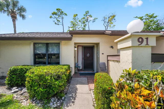 a front view of a house with a lots of yellow lighting