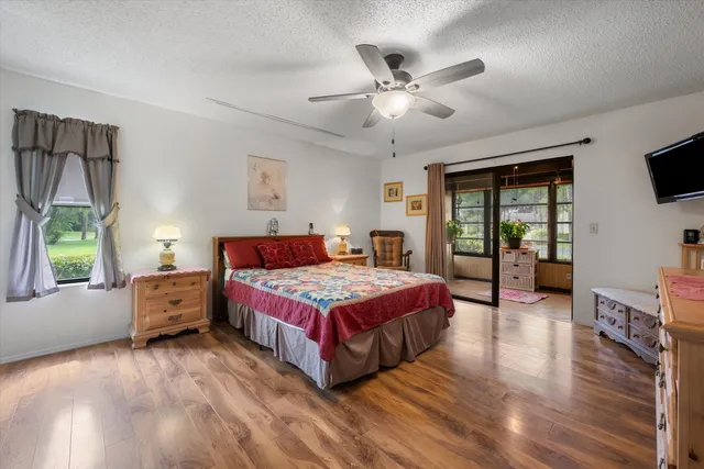 a bedroom with a large bed and a chandelier