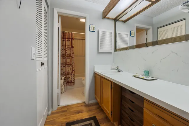 a bathroom with a sink a mirror and shower