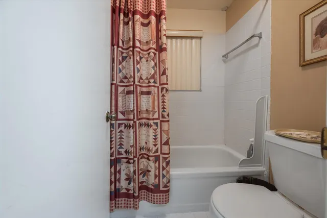 a bathroom with a toilet and a bathtub