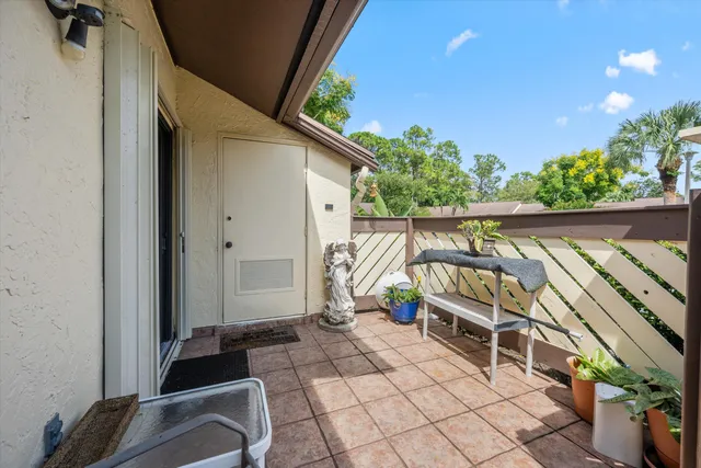 a balcony with furniture and potted plants