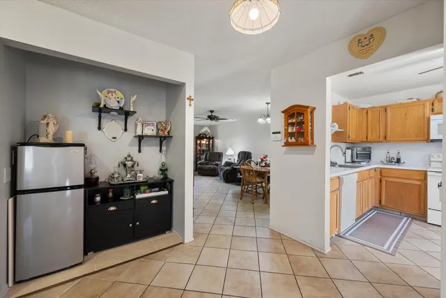 a kitchen with a refrigerator and cabinets