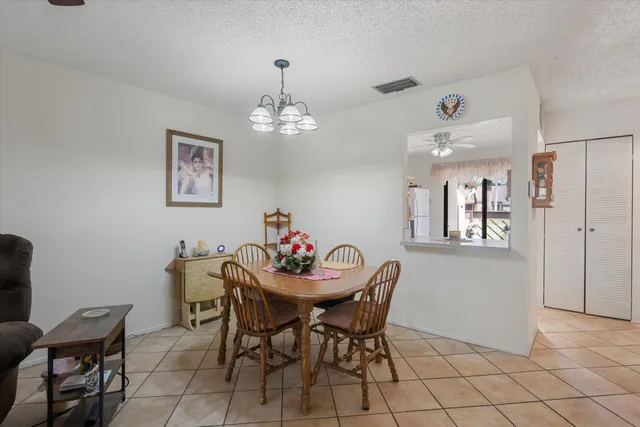 a view of a dining room with furniture and chandelier