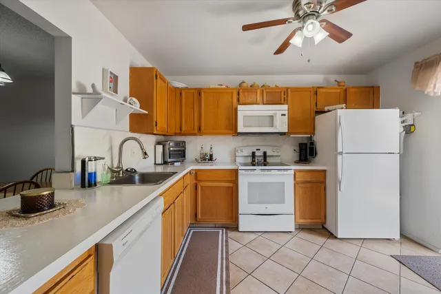 a kitchen with a refrigerator a sink and cabinets