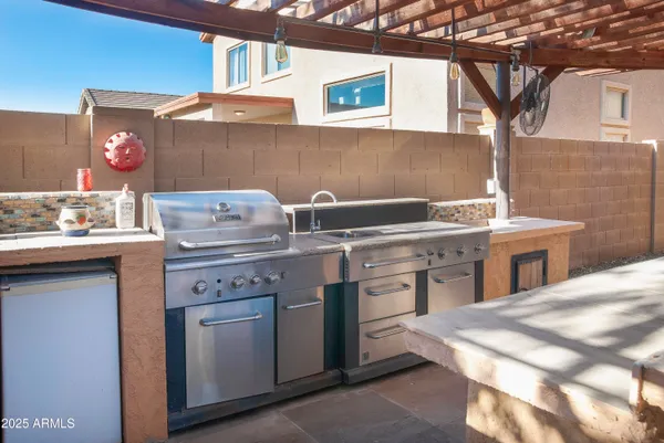 a kitchen with a sink stove and cabinets