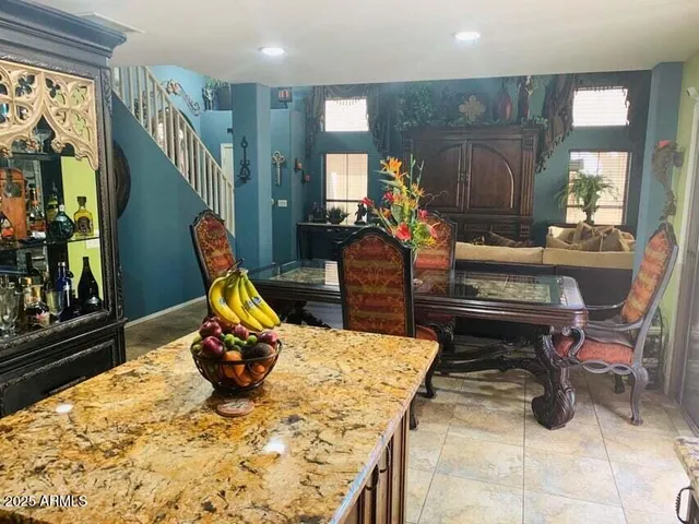 a room with furniture pool table and windows