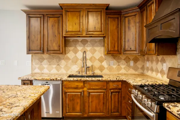 a kitchen with granite countertop a stove and cabinets