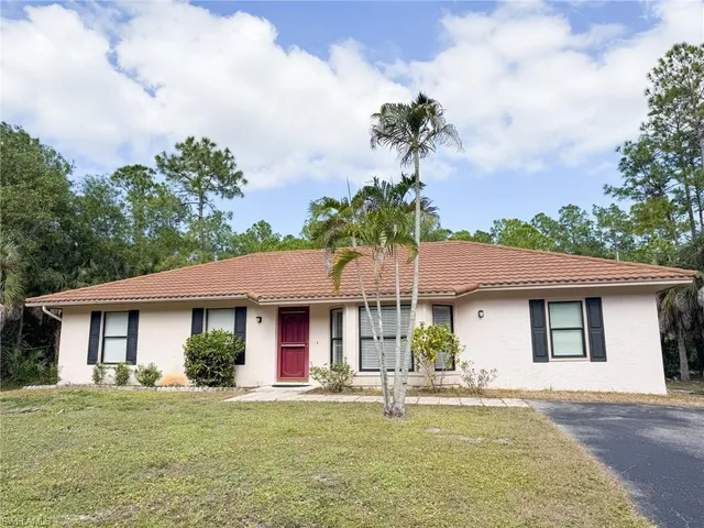 a front view of a house with a garden and porch