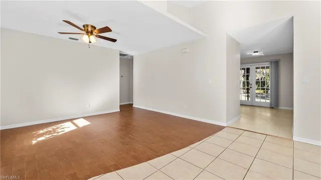 a view of a livingroom with wooden floor and a ceiling fan