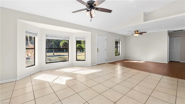 a view of a livingroom with a ceiling fan and window