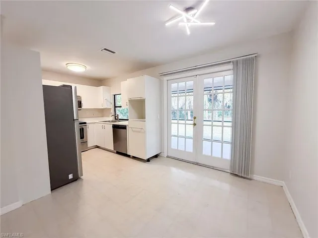 a view of kitchen with stainless steel appliances refrigerator oven and cabinets