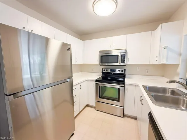 a kitchen with a refrigerator sink and stove