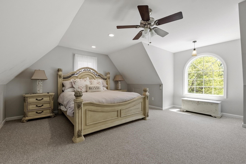 4 Ridge Road Pepperell, MA 01463 - Photo 31 of 42 a bedroom with a bed and a chandelier