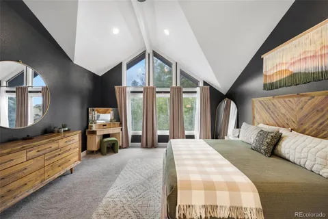 a bedroom with a large bed and a large window