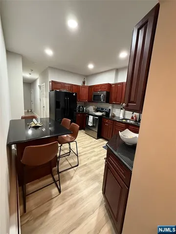 a living room with a table chairs and a kitchen