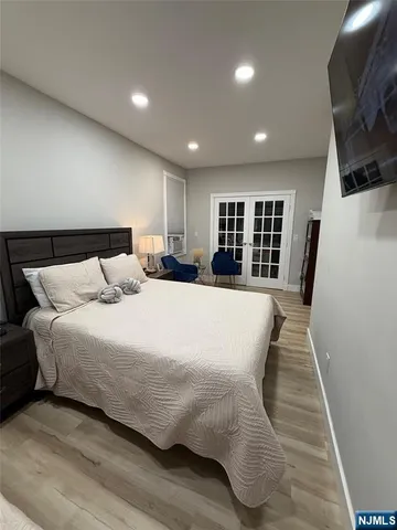 a view of an empty room with a fireplace and wooden floor