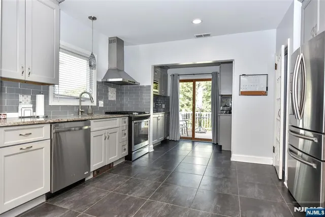 a kitchen with stainless steel appliances a refrigerator and cabinets