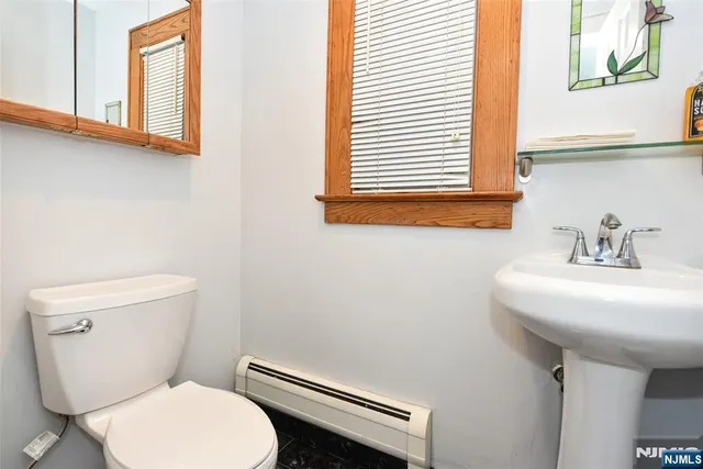 a view of a hallway with wooden floor and a window
