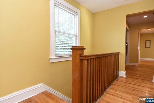 a spacious bedroom with a bed and cabinet