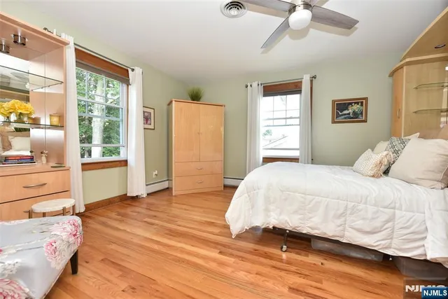 a view of room with window and wooden floor