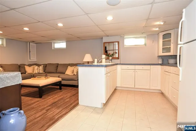 a kitchen with granite countertop a sink a window and cabinets