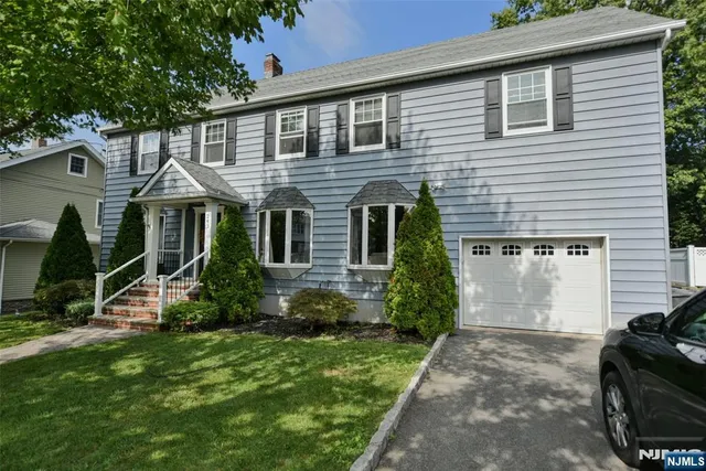 an entryway with wooden floor and mirror