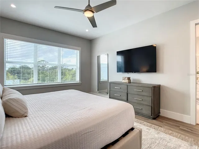 a bedroom with a bed and a flat screen tv