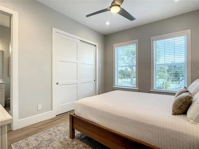 a bedroom with a large bed and a window