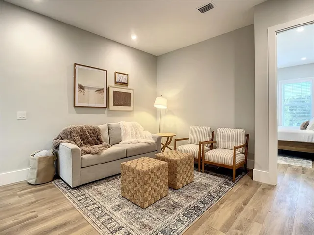 a living room with couches and painting on the wall